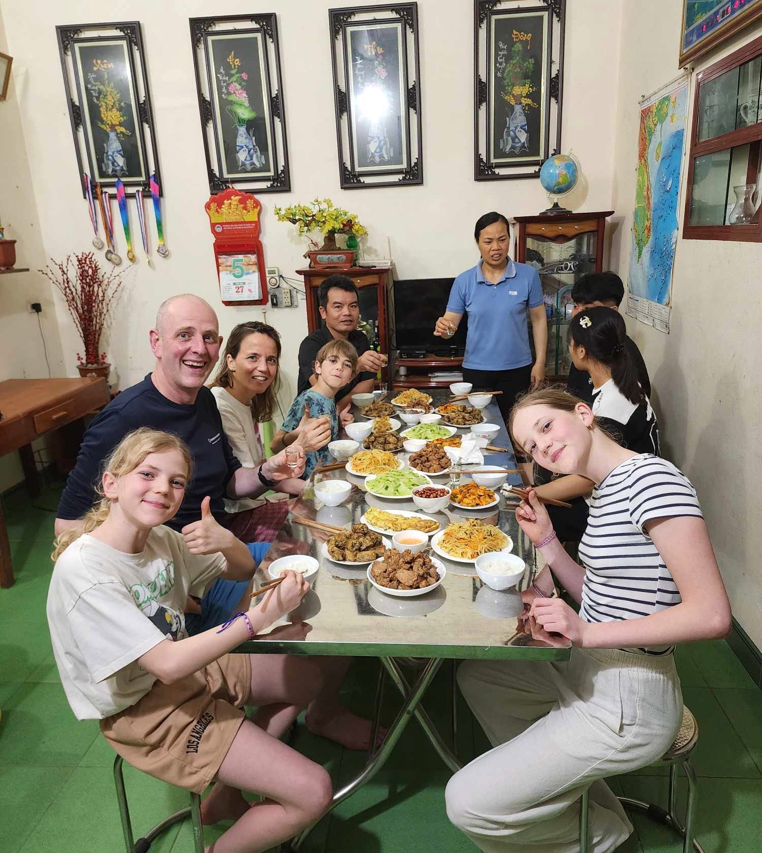 Family with children having dinner at a local home in Ninh Binh